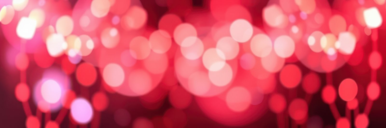 Vibrant bokeh lights create an enchanting atmosphere during a festive gathering in a decorated venue at night